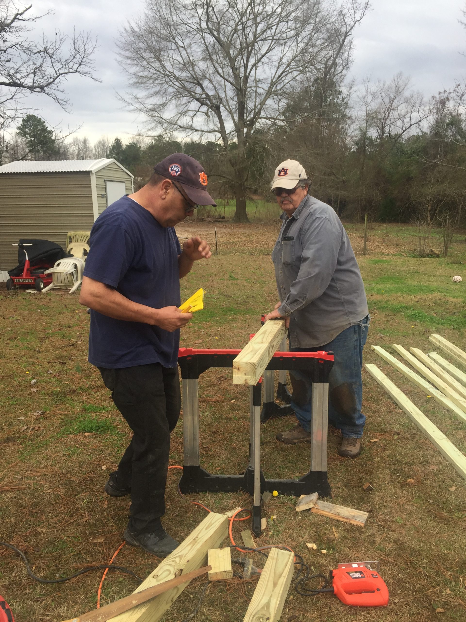 two people sawing